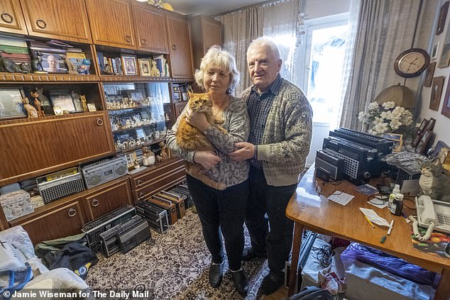 Refusing to leave: 72 year old Anatolii and his wife Nadia, 69, and one of their cats Martha, pictured in their tenth floor apartment in the Obolonskyi District of Kyiv, where they vow they will stay until the end of the war