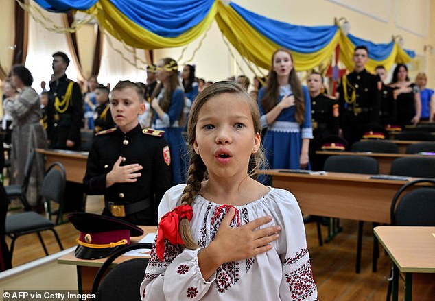 Ukrainian writer Andrey Kurkov's work has been translated into 37 languages. He has now produced his Diary Of An Invasion, about Putin's invasion of Ukraine. Pictured: Ukrainian children singing the national anthem
